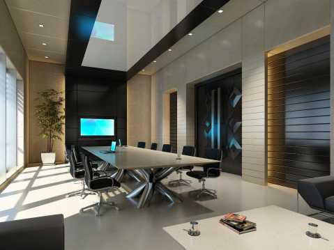 Empty executive briefing room with a large conference table and tv screen