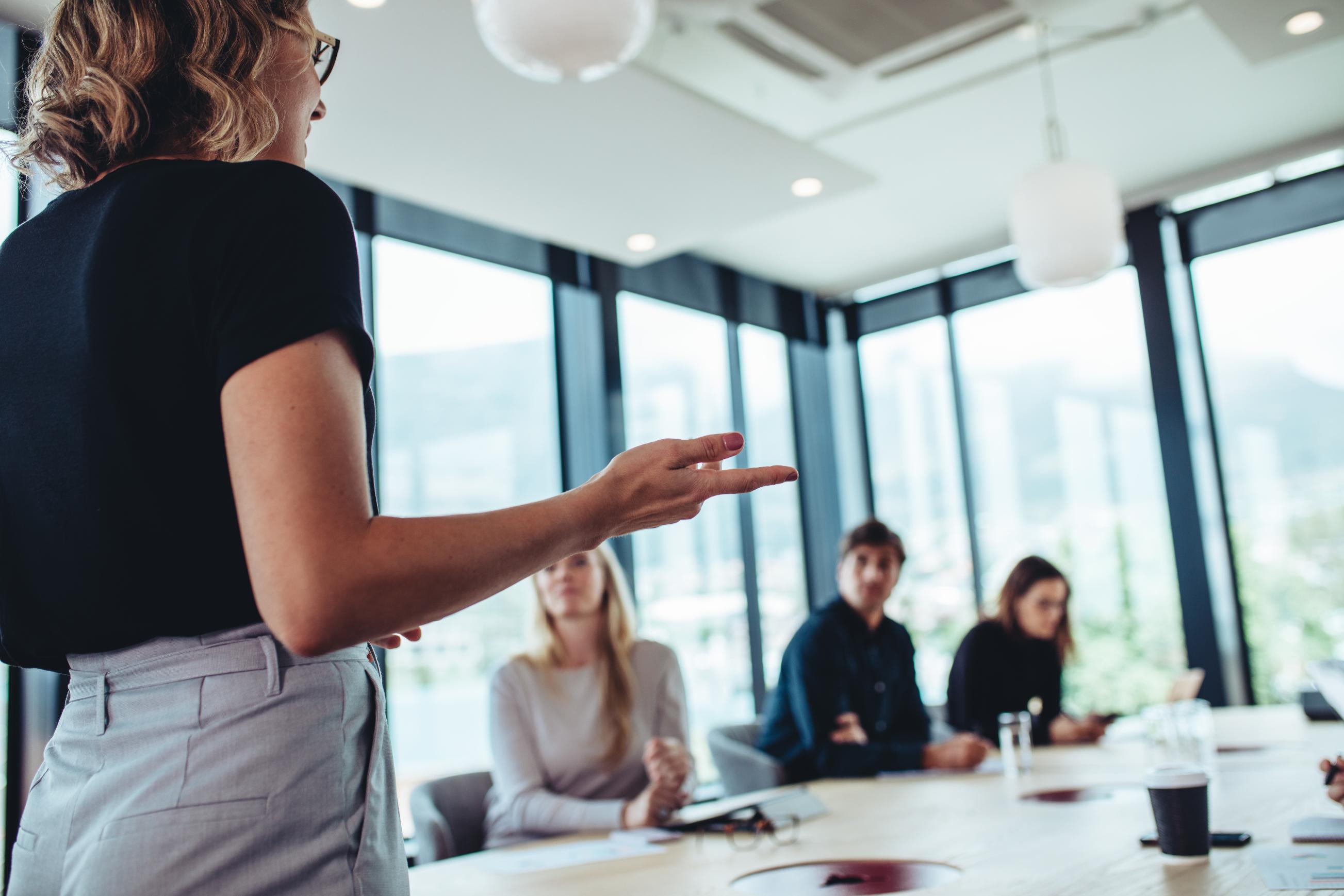 Businesswoman making presentation to colleagues in a conference room